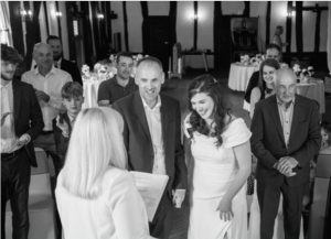 Joanne Jefferis conducting a wedding at alter with bride and groom