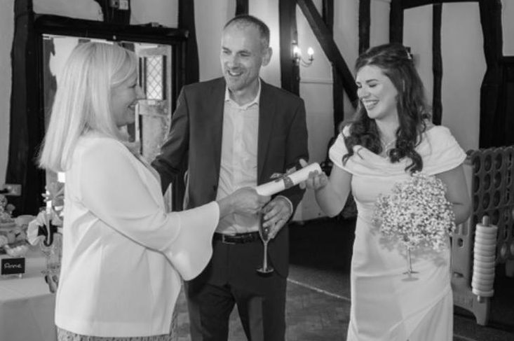 Joanne Jefferis Celebrant handing wedding scroll to bride and groom