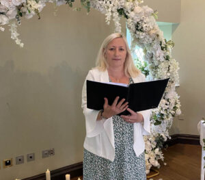 Joanne-Jefferis-Wedding Celebrant-floral arch backdrop reading vows